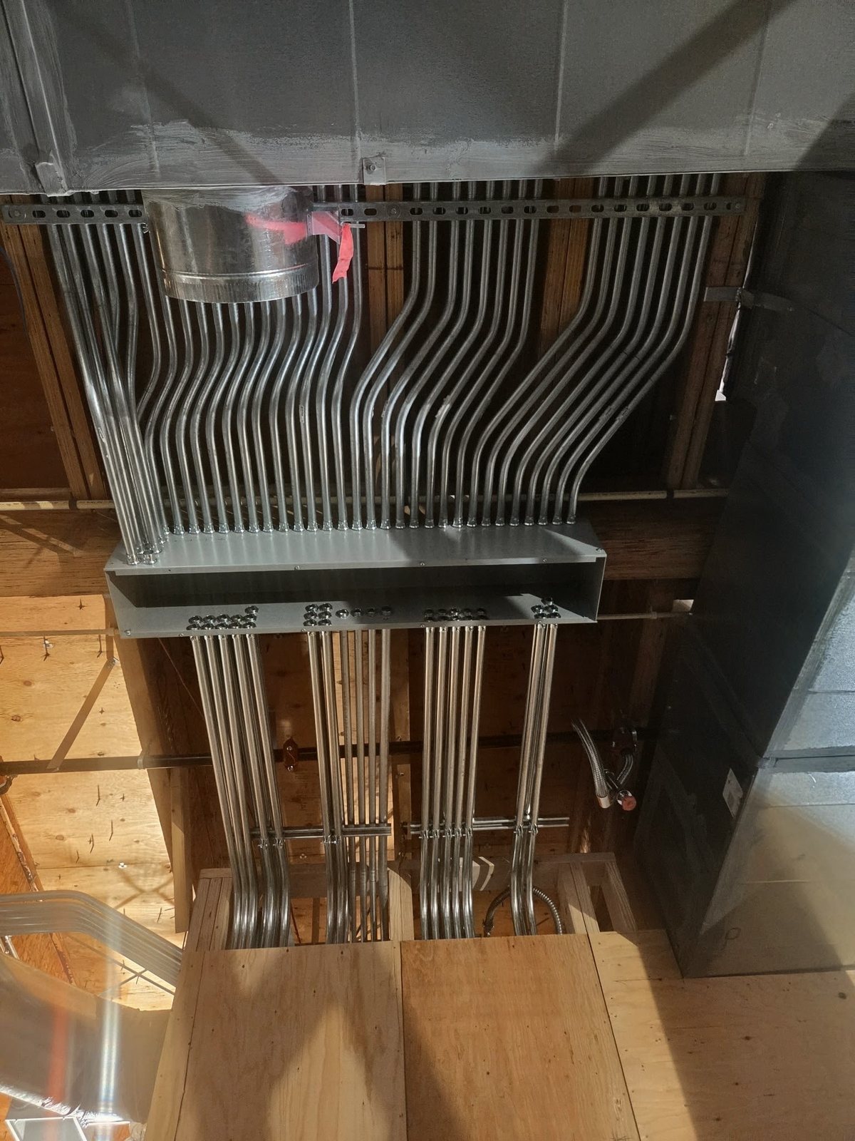 EMT conduit entering a trough on a commercial rough-in